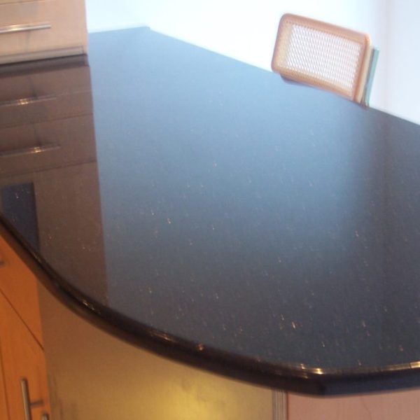 Elegant Black Galaxy granite countertop featuring a glossy black surface with shimmering gold flecks—perfect for modern kitchens