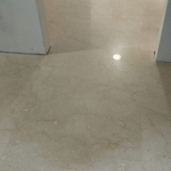 Warm beige Botticino marble flooring with subtle patterns and a glossy surface.