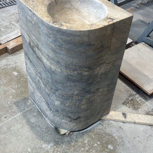 A monolithic sink crafted from premium silver travertine, showcasing the stone’s natural veining and timeless elegance.