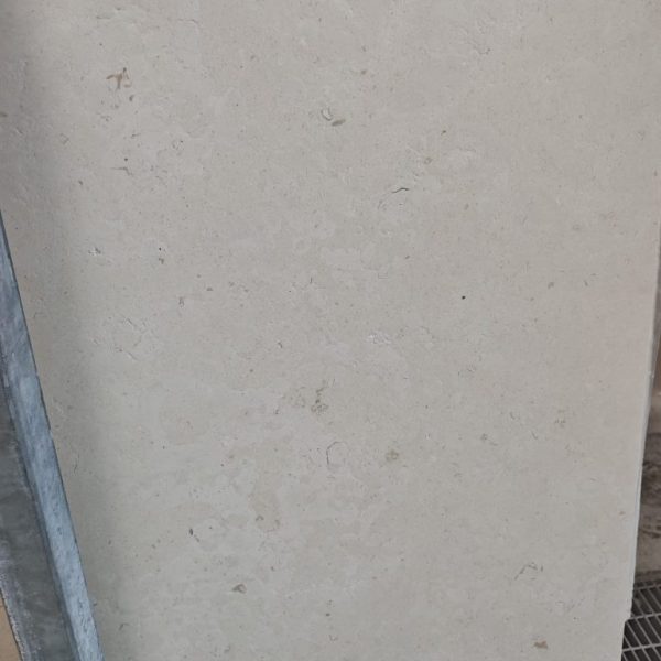 A refined limestone surface with the distinctive soft beige elegance of Crema Luna